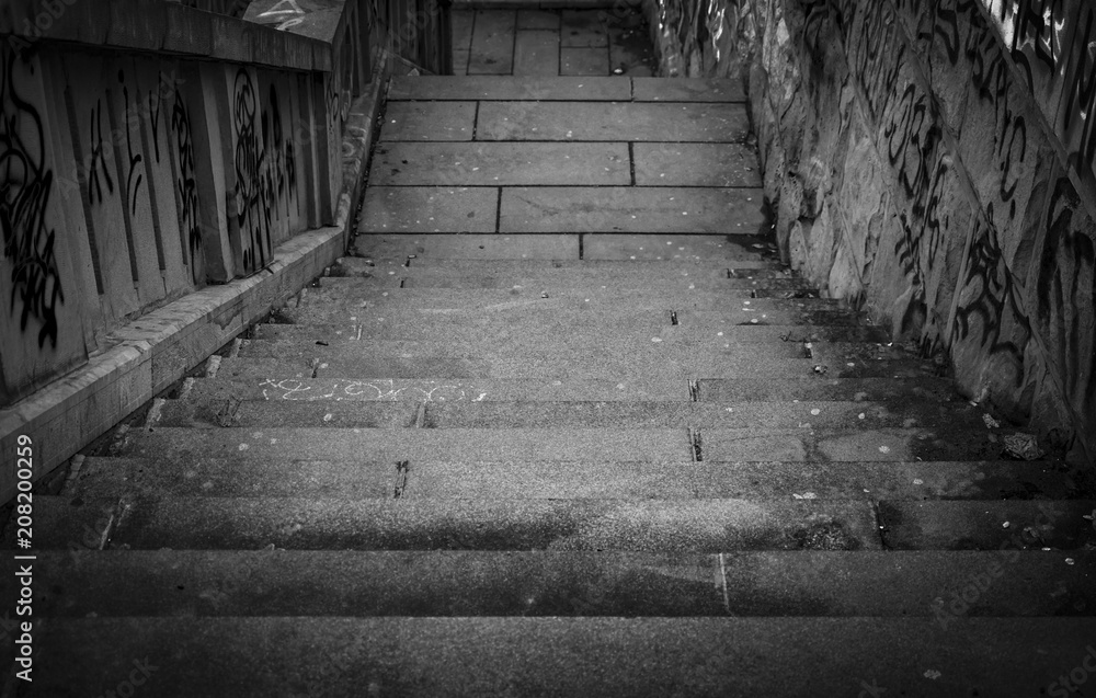 Black and white stairs going down with a lot grafiti Black and white stairs going down with a lot grafiti