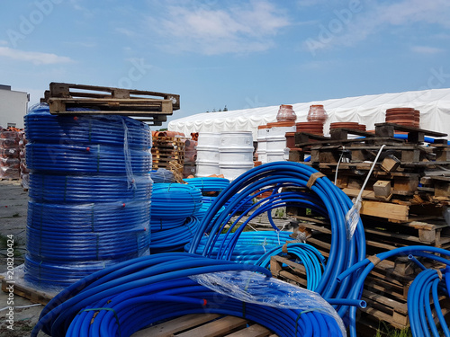A warehouse of plastic pipes for various purposes, diameter and color under the open sky. Manufacture and sale of plastic products for construction works.om plastic. Drainage and sewerage. 