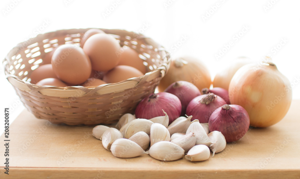 Onions garlic and eggs on white background Onions garlic and eggs on white background