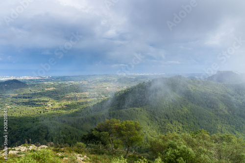 Mallorca, Foggy atmosphere over green wooded mountain range of Sant Salvador © Simon