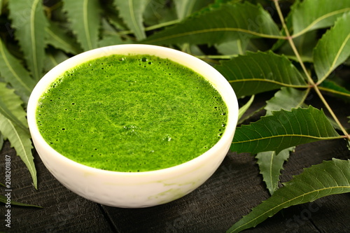 Herbal medicine- wild neem leaves cream in white bowl.