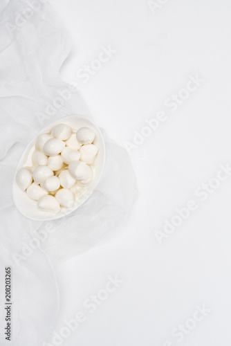 top view of delicious mozzarella cheese curds on white surface