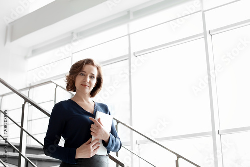 Quadro su tela Female lawyer standing with tablet in office