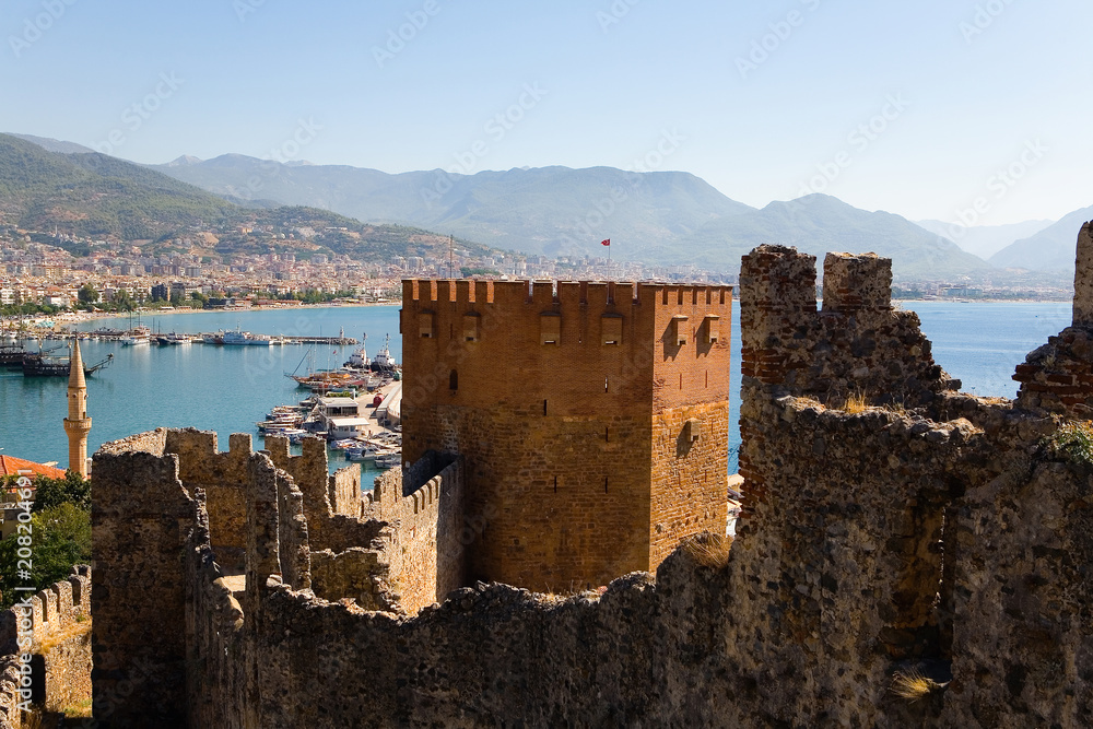 Ruins of an old fortress against the background of the Mediterranean Sea.