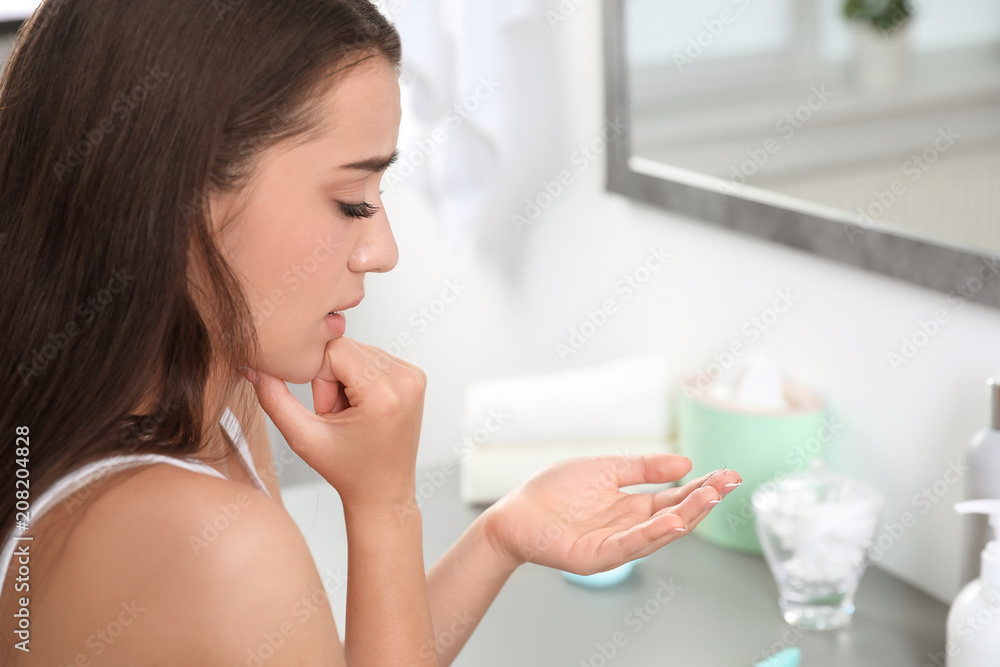 Young woman with eyelash loss problem indoors Young woman with eyelash loss problem indoors