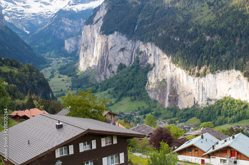 Houses in Wengen village with Lauterbrunnen valley in background photo