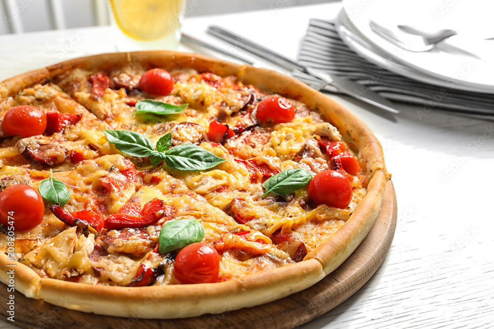 Delicious pizza with tomatoes and sausages on table Delicious pizza with tomatoes and sausages on table