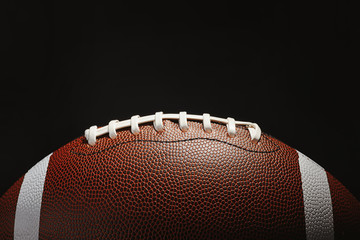 New American football ball on dark background