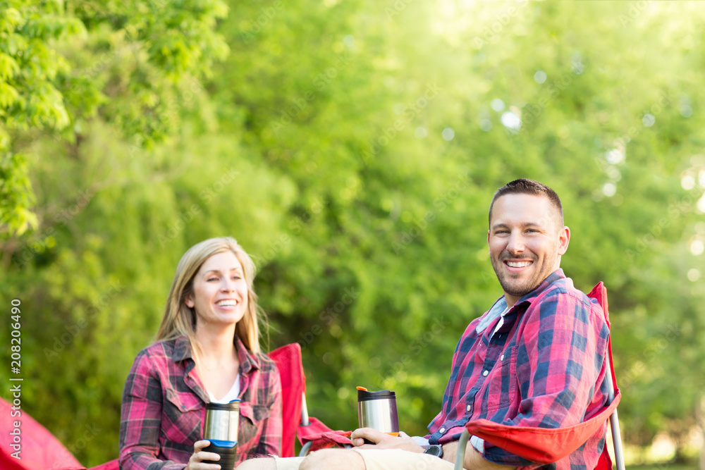 Couple talking and laughing on a camping trip. Couple talking and laughing on a camping trip.