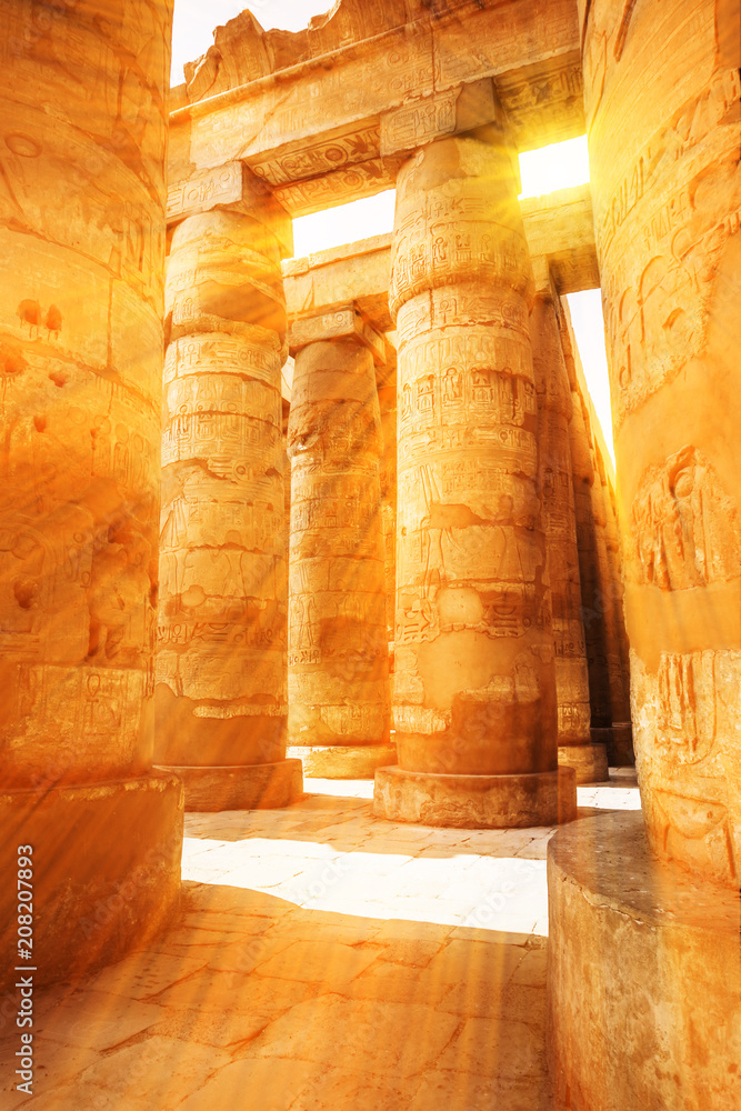A sandstone column in Egypt. columns covered in hieroglyphics A sandstone column in Egypt. columns covered in hieroglyphics