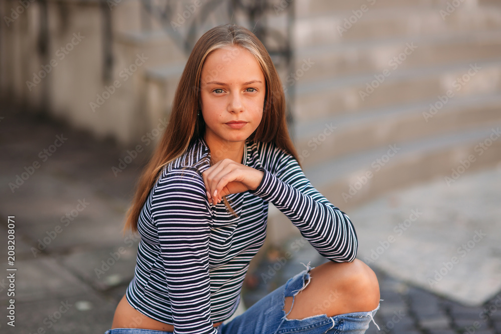 young teenage poses for photo. blonde girl in jeans and blouse Stock ...
