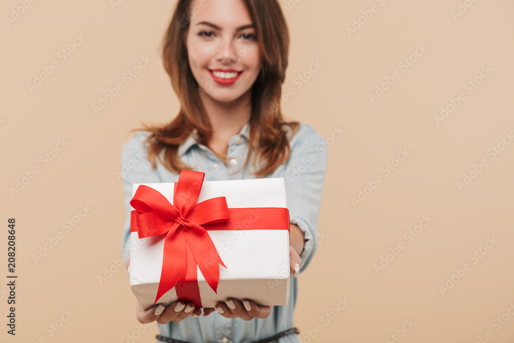 Portrait of a happy young girl giving present box Portrait of a happy young girl giving present box