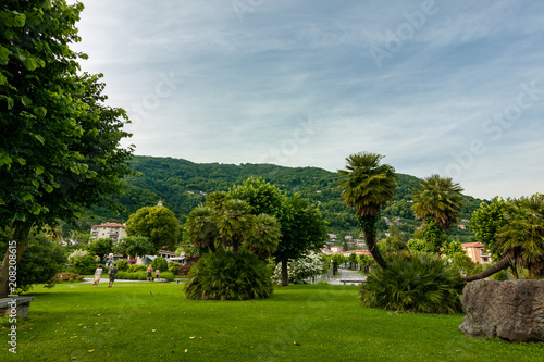 Garden on the shore of Lake Maggiore, tourist on the Cannero Riviera Beach