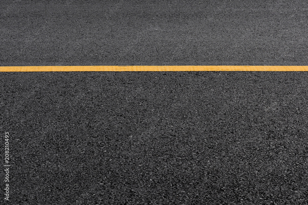 Yellow paint line on black asphalt. space transportation background