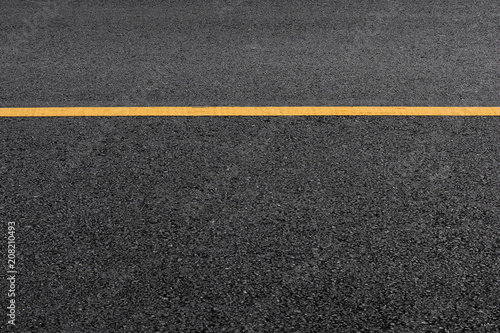 Yellow paint line on black asphalt. space transportation background © sema_srinouljan