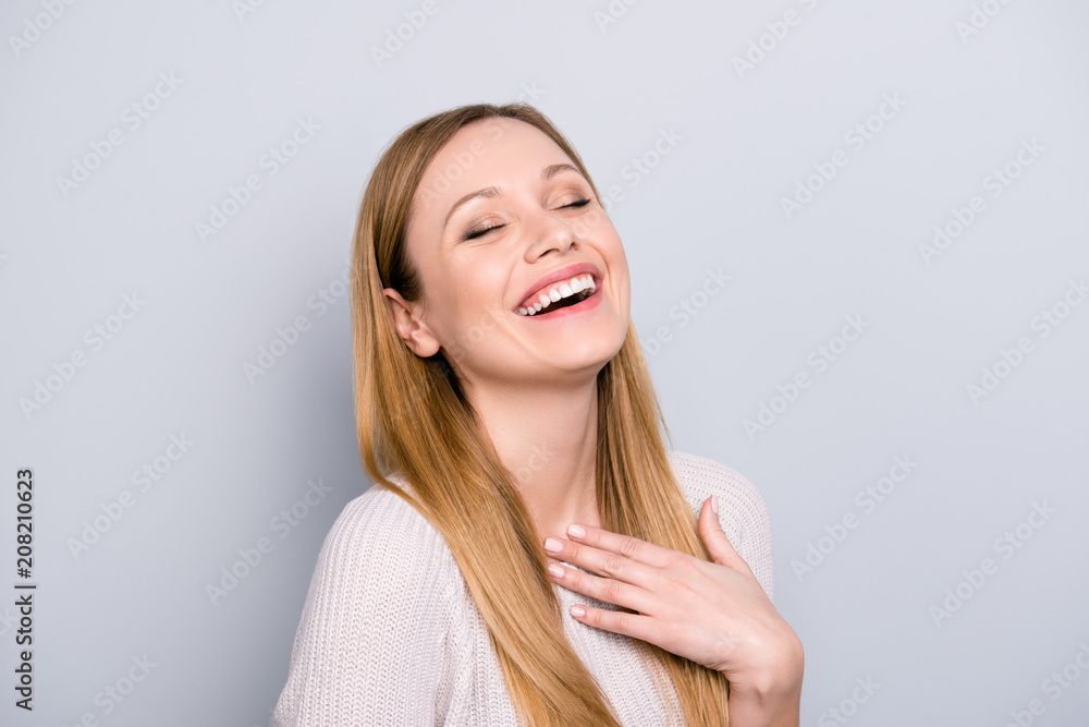 Portrait of funny cheerful girl laughing with close eyes beaming smile enjoying joke isolated on grey background. Positive lifestyle concept Portrait of funny cheerful girl laughing with close eyes beaming smile enjoying joke isolated on grey background. Positive lifestyle concept