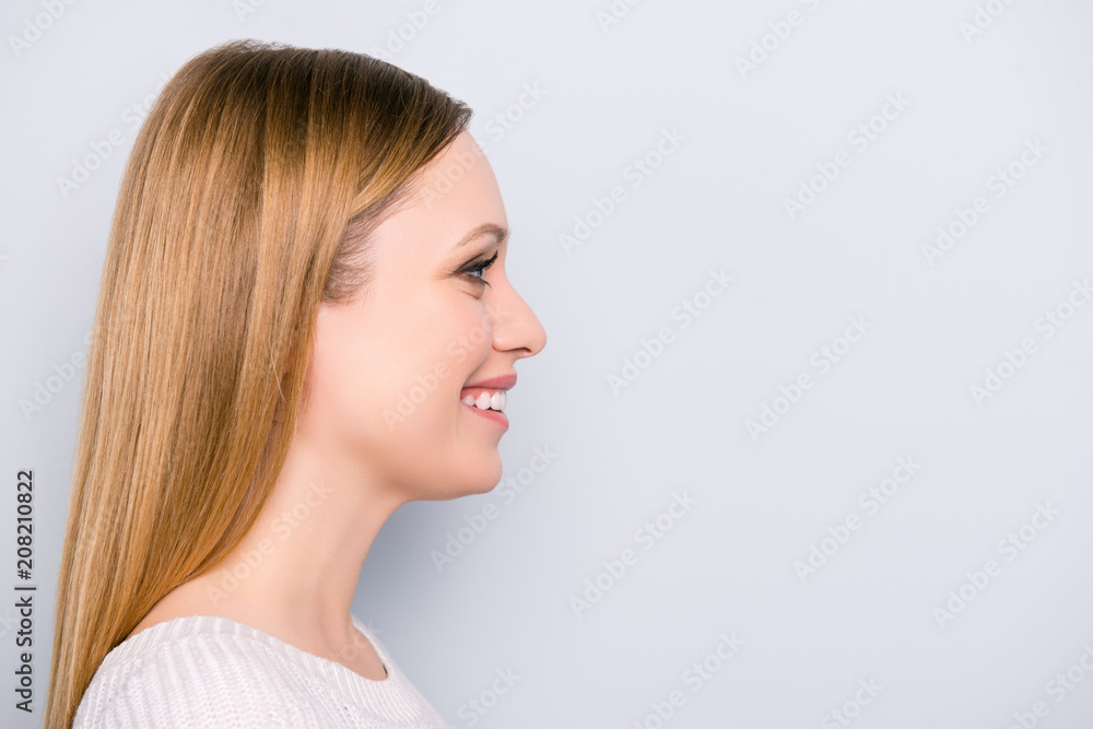 Profile portrait of charming pretty girl isolated on grey background with copy space empty place for product. Fashion beauty concept Profile portrait of charming pretty girl isolated on grey background with copy space empty place for product. Fashion beauty concept