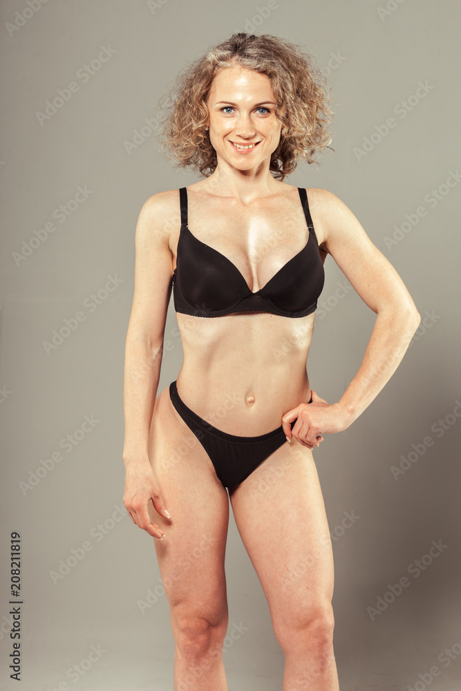 Fototapeta premium Young woman with beautiful slim perfect body in bikini