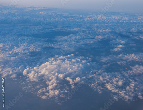 Evening sunset sky from the window of the airplane.  View of the beautiful sky and clouds from the window of the airplane. 