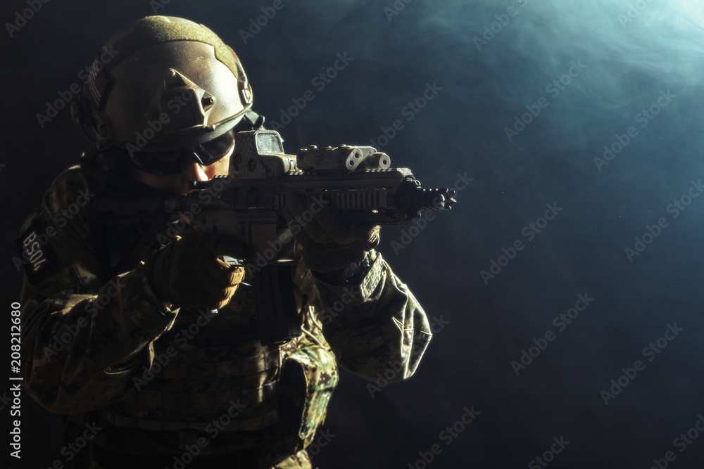 Fototapeta premium Special forces soldier with rifle on dark background
