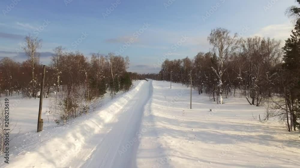 aerial view on ural plateau and rural winter snowy empty road in forest / Ural Mountains Russia aerial view on ural plateau and rural winter snowy empty road in forest / Ural Mountains Russia