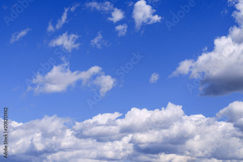 Fototapeta Naklejka Na Ścianę i Meble -  White fluffy clouds in the vast blue sky. Abstract nature background.