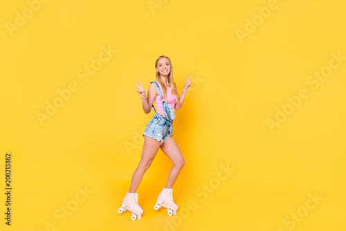 Photography Full size body portrait of attractive pretty girl riding on roller skates gestur