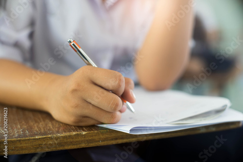 Wallpaper Mural Close up Students writing and reading exam answer sheets exercises in classroom of school with stress. Torontodigital.ca