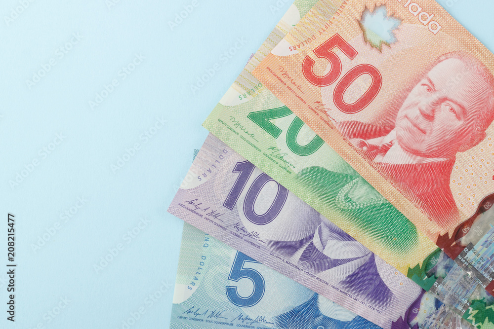 Obraz premium Canadian banknotes on blue background