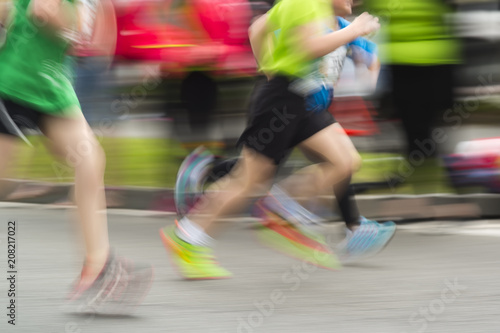 athletics runners competitors in city race in motion blur