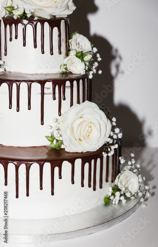 Wedding cake with chocolate and flowers photo