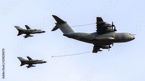 Bilde på lerret Military tanker aircraft aerial refuelling two air force fighter bomber jets