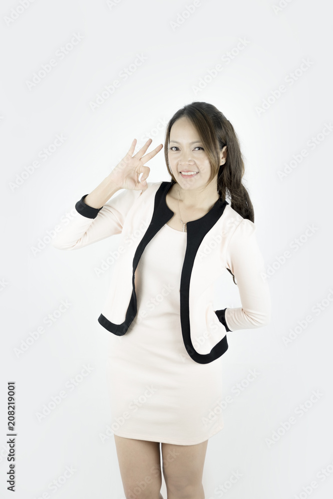 Asian young Businesswoman showing OK hand sign smiling happy.