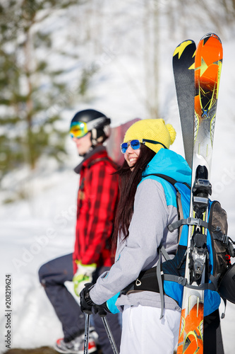 Image of sports men and women with mountain skis walking on snow hill