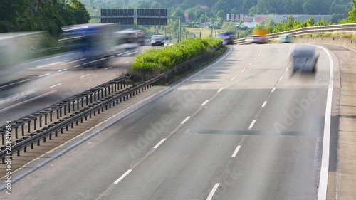 Traffic jam on german highway autobahn A3 through green hilly landscape with cars, trucks and busses - time lapse
