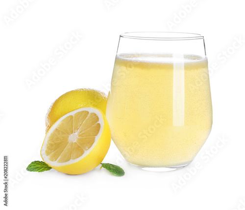 Glass with delicious citrus juice and fresh fruits on white background