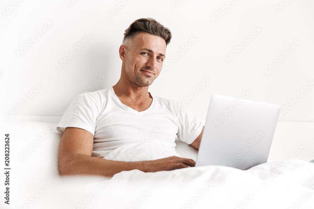 Happy man using laptop computer Happy man using laptop computer