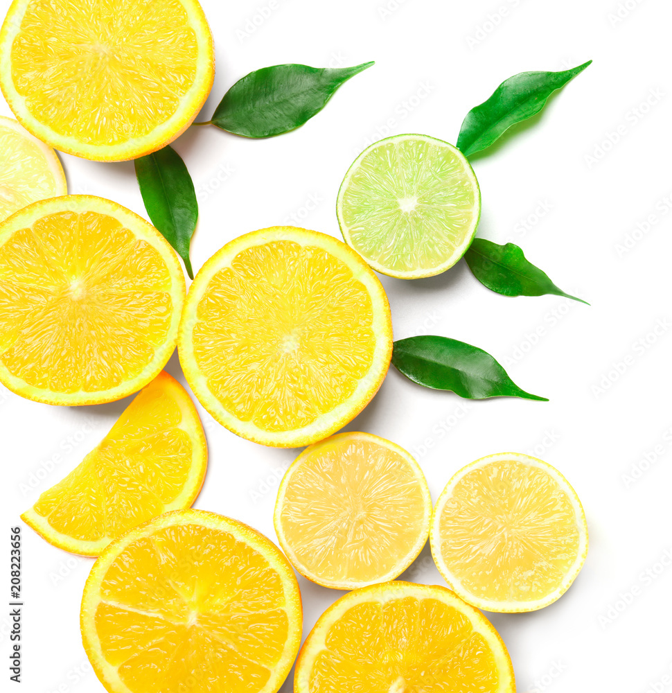 Composition of delicious citrus fruits and green leaves on white background