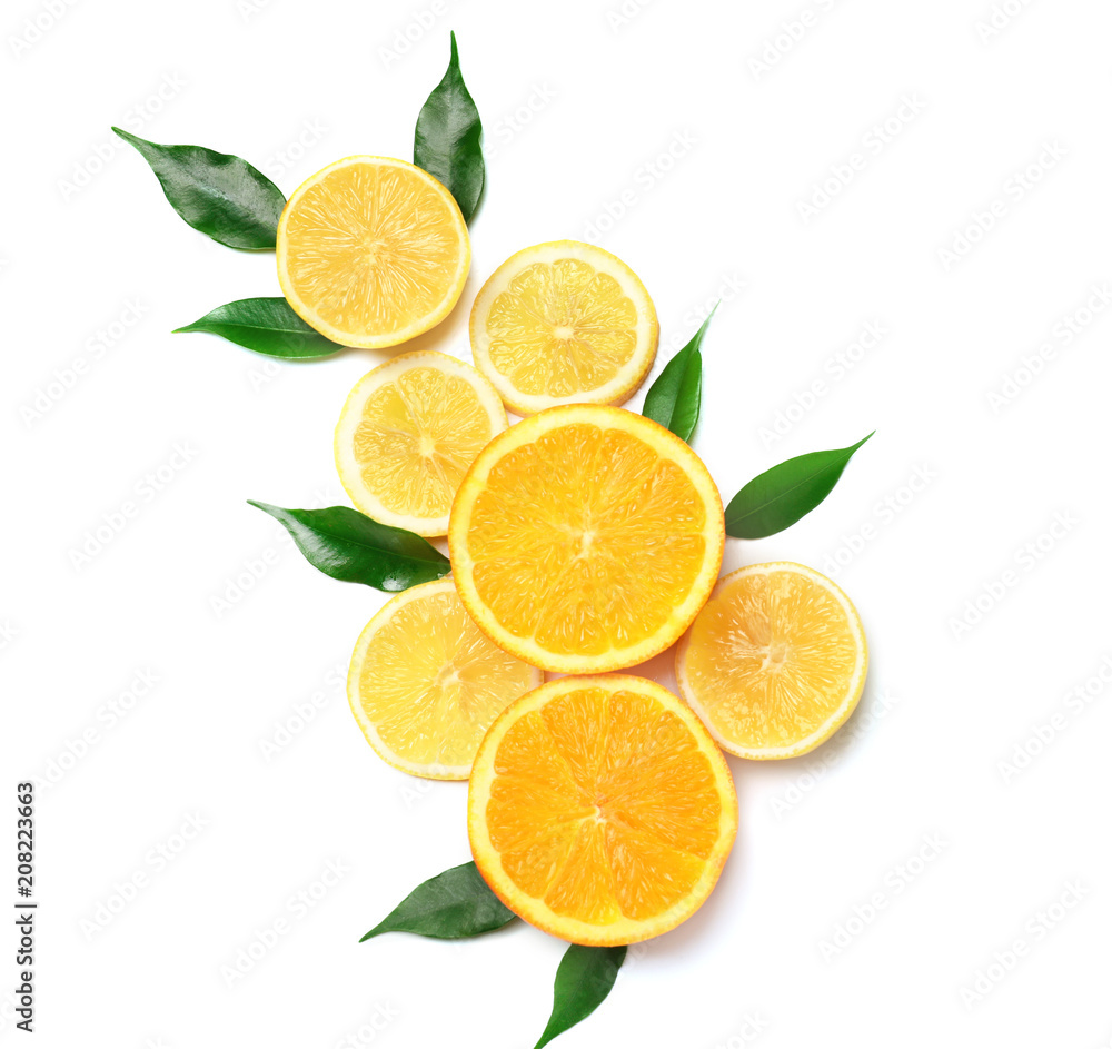 Composition of delicious citrus fruits and green leaves on white background Composition of delicious citrus fruits and green leaves on white background