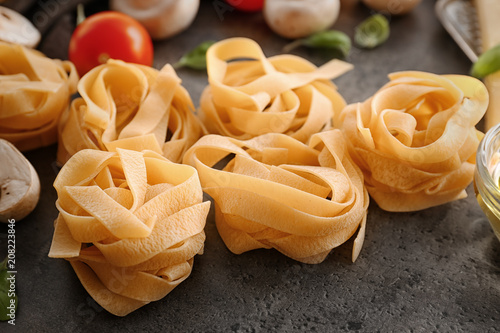 Uncooked fettuccine pasta on table
