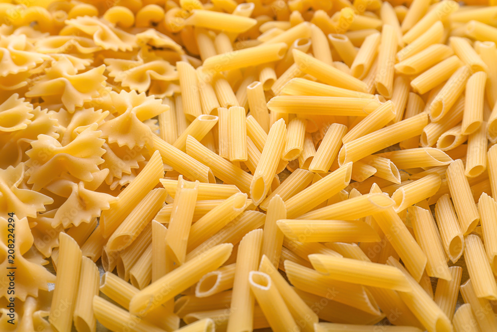 Different uncooked pasta as background, closeup Different uncooked pasta as background, closeup