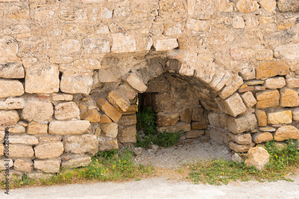 Arched entrance in an ancient stone wall