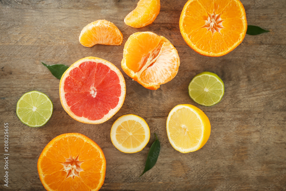 Flat lay composition with ripe citrus fruits on wooden background Flat lay composition with ripe citrus fruits on wooden background
