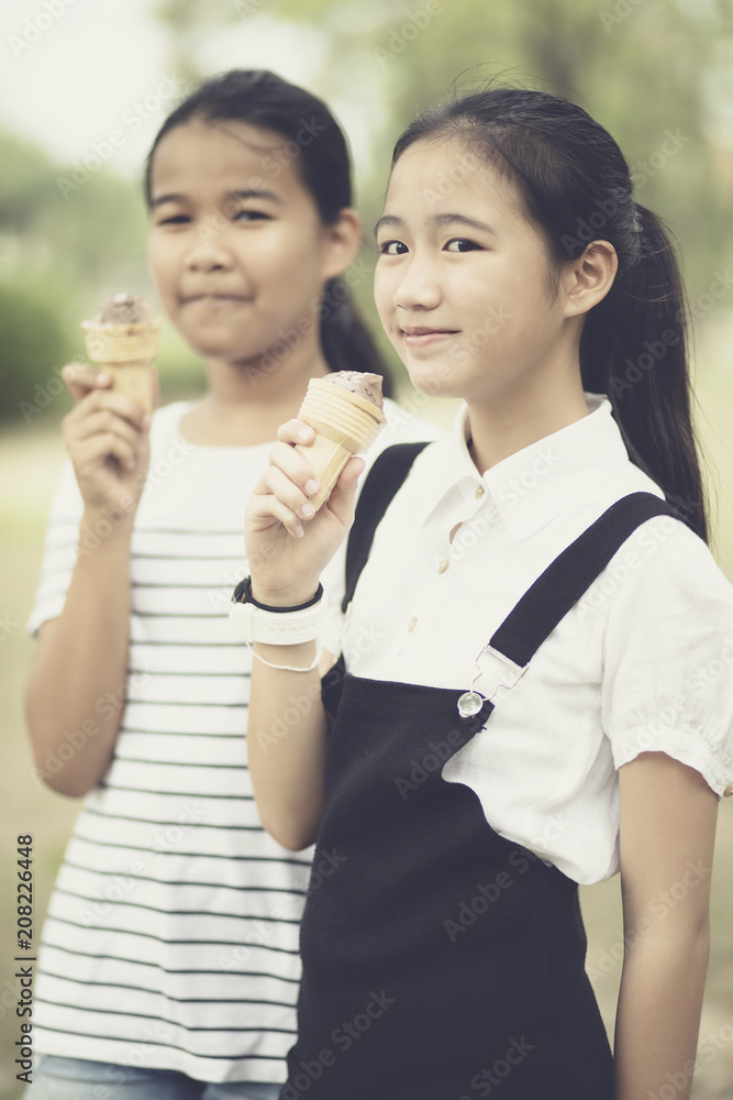 asian teenager eating icecream cone with happiness face asian teenager eating icecream cone with happiness face