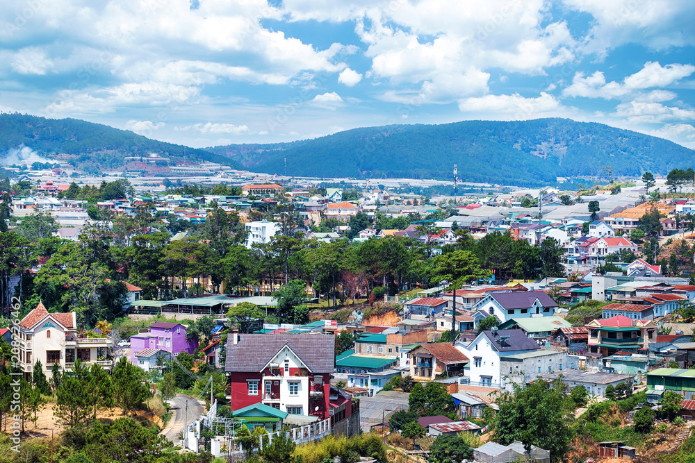 Beautiful houses with in the Da Lat city (Dalat) on the blue sky background in Vietnam. Da Lat and the surrounding area is a popular tourist destination of Asia.