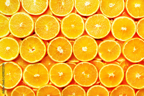Creative pattern. Fresh sliced orange fruit texture. Macro, top view with copy space. Food frame. Juicy oranges background. banner