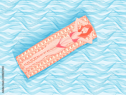 Beautiful young woman lies on a inflatable beach mattresses and sunbathing on blue sea background