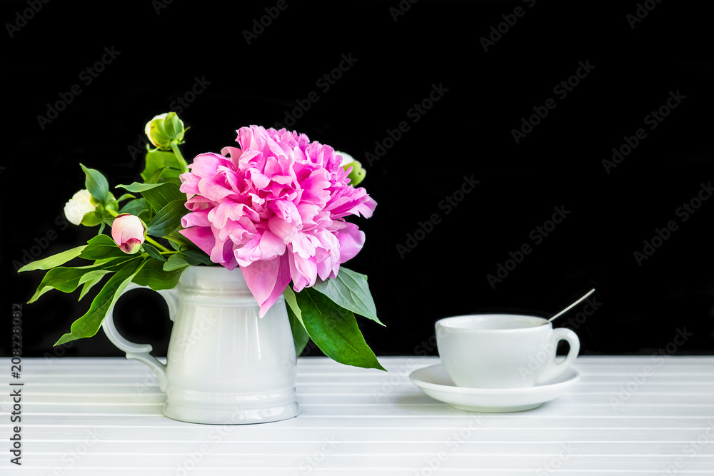 A cup of tea and peonies