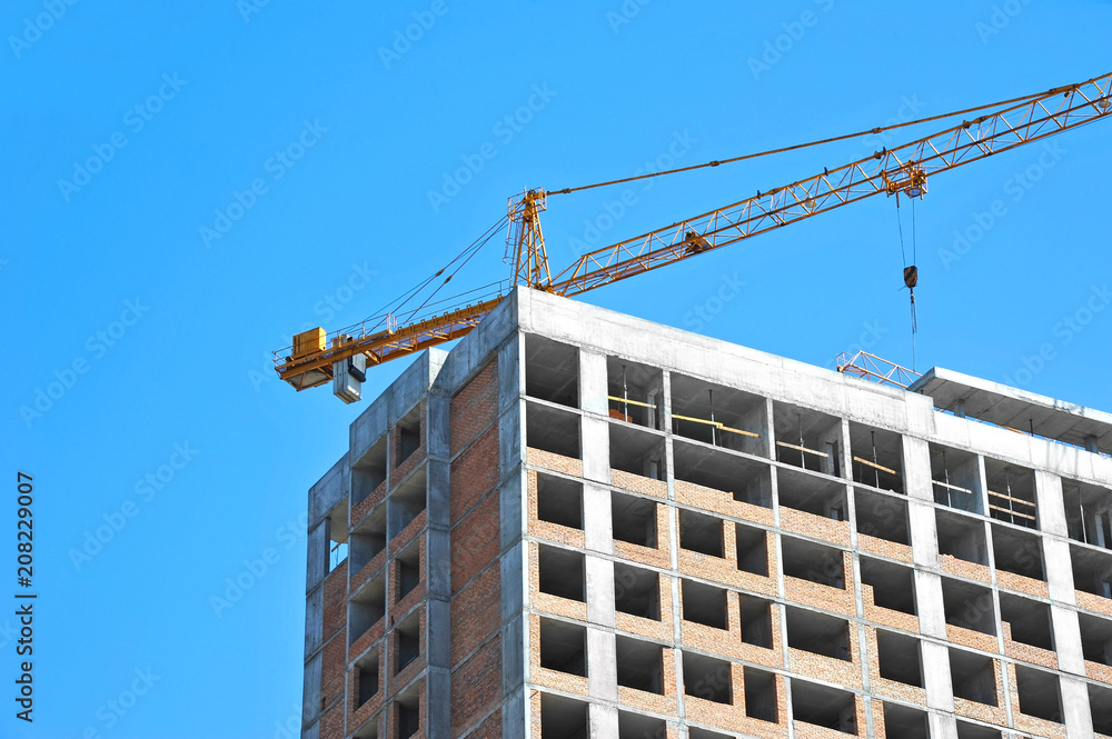Crane and highrise construction site Crane and highrise construction site