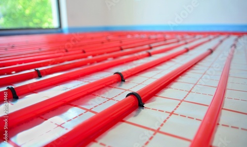 Slika na platnu Water underfloor heating pipes on the silver reflective foil in house construction